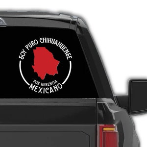 May include: A black pickup truck with a white vinyl decal on the rear window. The decal features a red outline of the state of Chihuahua, Mexico, with the text "Soy Puro Chihuahuense Por Herencia Mexicano".