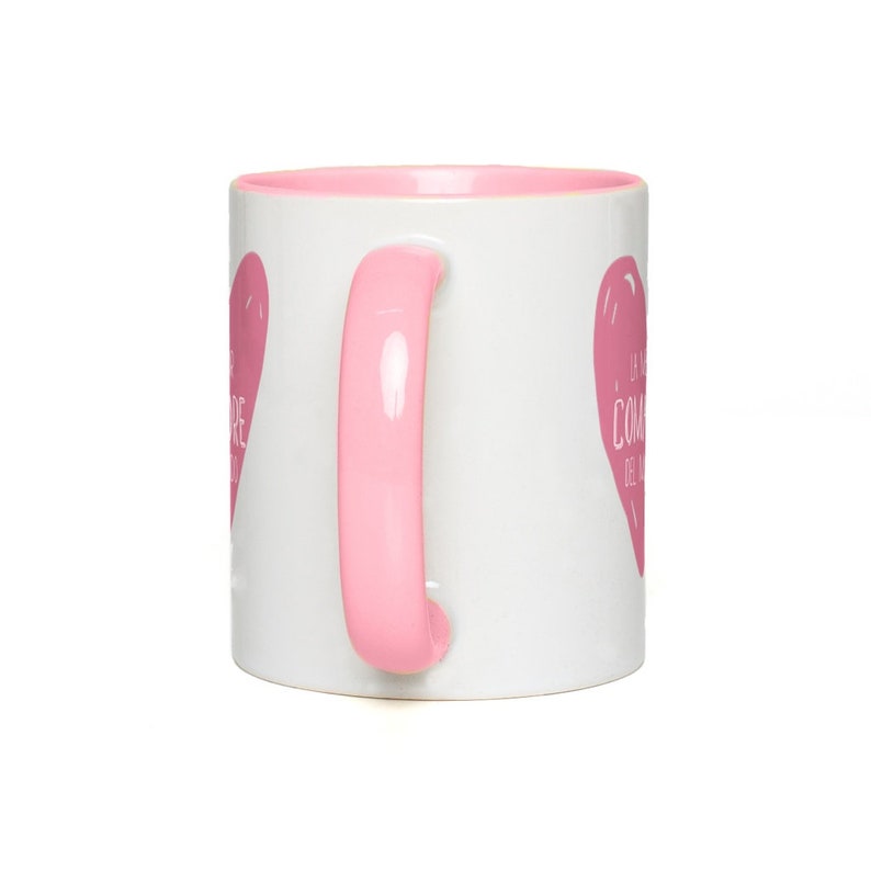 May include: White ceramic mug with a pink rim and handle. The mug has a pink heart design with the text "La vita &egrave; come una tazza di caff&egrave;" in white.