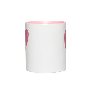 May include: A white ceramic mug with a pink rim and a pink heart design on each side.