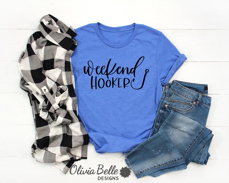 Peut inclure: Un t-shirt bleu avec le texte "Weekend Hooker" en lettres noires et un graphique de crochet de p&ecirc;che.