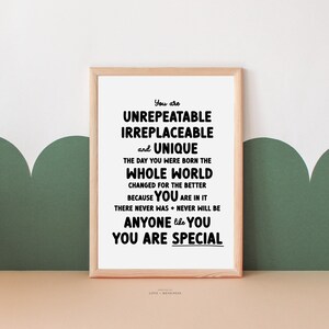 May include: A framed print with a white background and black text that reads "You are UNREPEATABLE IRREPLACEABLE and UNIQUE THE DAY YOU WERE BORN THE WHOLE WORLD CHANGED FOR THE BETTER BECAUSE YOU ARE IN IT THERE NEVER WAS + NEVER WILL BE ANYONE like YOU YOU ARE SPECIAL".