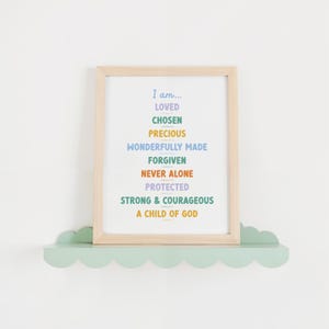 catholic kids bible affirmation printable in a light wood frame on a teal scalloped shelf