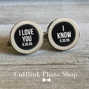 May include: A pair of silver cufflinks with black enamel. One cufflink says "I LOVE YOU 9.30.95" and the other says "I KNOW 9.30.95".