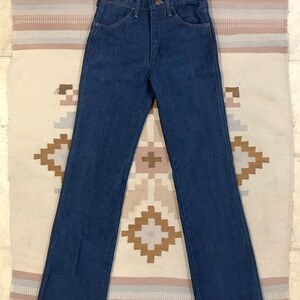 May include: A pair of dark blue denim jeans with a straight leg and a high waist.