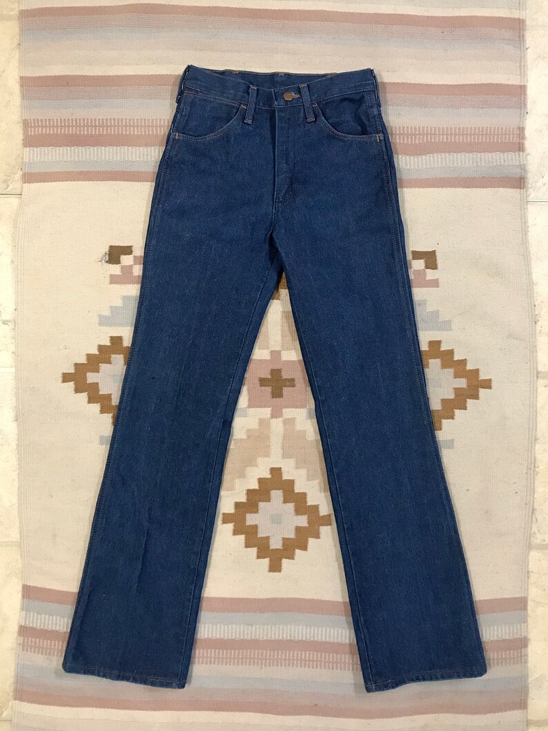 May include: A pair of dark blue denim jeans with a straight leg and a high waist.