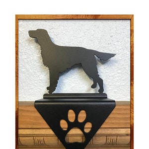 May include: Black metal stocking holder featuring a silhouette of a Gordon Setter dog with a paw print design.