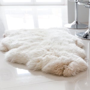 Cream white sheepskin rug laying flat on the dining room floor