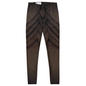 May include: Brown leggings with a layered, textured design. The leggings feature a series of overlapping, angular shapes in varying shades of brown, creating a visual pattern. The fabric appears soft and comfortable, suitable for casual wear.