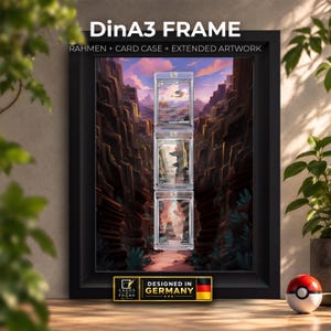 May include: A black DinA3 frame containing three vertical card cases with trading cards, set against an extended canyon landscape artwork. The frame features the text DinA3 FRAME, RAHMEN + CARD CASE + EXTENDED ARTWORK, and a label stating DESIGNED IN GERMANY.