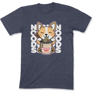 May include: A navy blue t-shirt with a cartoon corgi dog eating a bowl of noodles. The text "NOODS" is repeated around the dog.