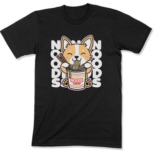 May include: Black t-shirt with a cartoon corgi dog eating ramen noodles from a red and white bowl. The text "NOODS" is printed on the bowl. The text "NOODS" is repeated in a vertical pattern on the shirt.