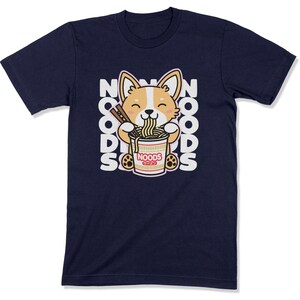 May include: A navy blue t-shirt with a cartoon corgi dog eating a bowl of noodles. The text "NOODS" is repeated around the dog.