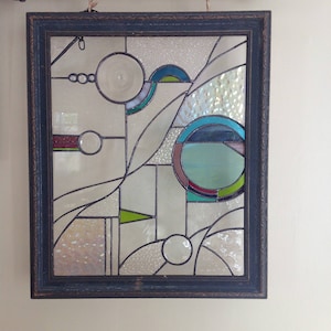 Geometric stained glass panel with antique wooden frame