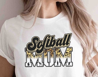 May include: White t-shirt with a black and gold graphic that says "Softball Mom" with a leopard print design.
