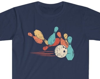 May include: A navy blue t-shirt featuring a vintage-style graphic of bowling pins and a bowling ball. The pins are in various colours, including orange, yellow, blue, and green. The bowling ball is white with black stitching.