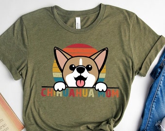 May include: A green t-shirt with a retro sunset graphic and a cartoon chihuahua peeking over the top. The text "Chihuahua Mom" is printed below the image.