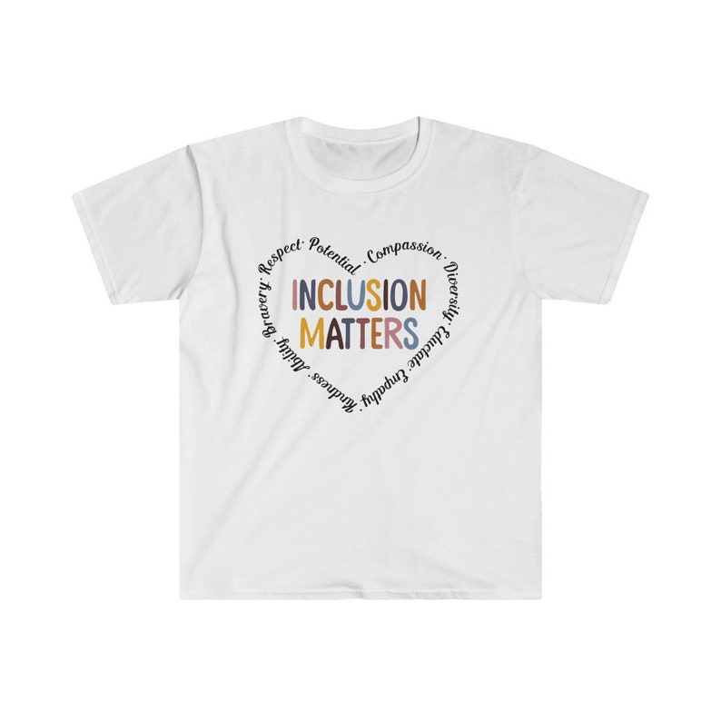 May include: White t-shirt with a circle graphic that says "Inclusion Matters" in colorful letters. The circle is surrounded by the words "Respect, Potential, Compassion, Diversity, Educate, Empathy, Kindness, Ability, Bravery."