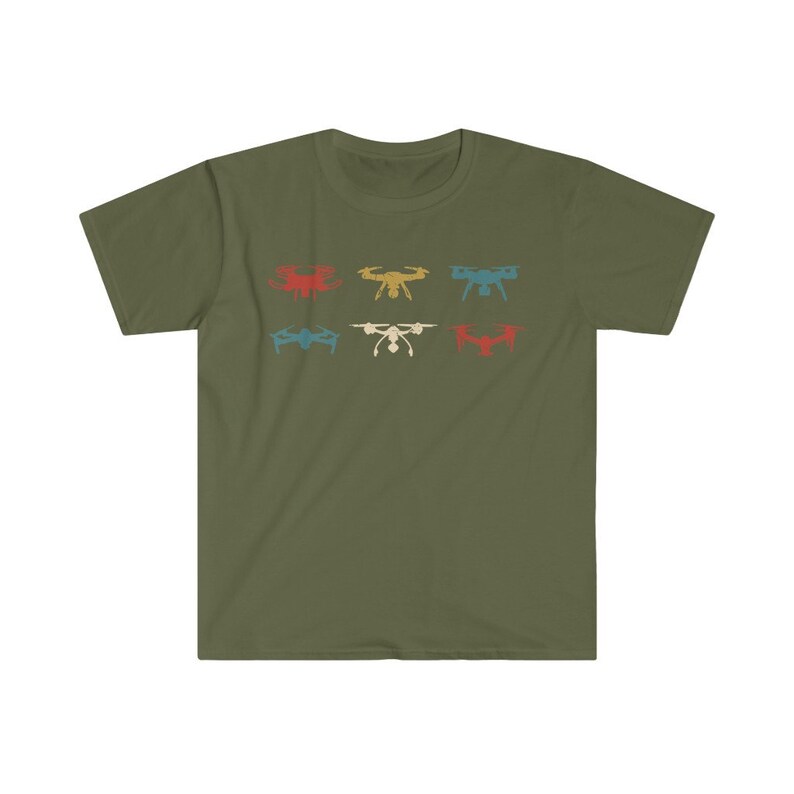 May include: Olive green t-shirt featuring a retro design of six drones in various colors: red, yellow, blue, teal, white, and red. The drones are arranged in two rows of three. A casual, short-sleeved tee.