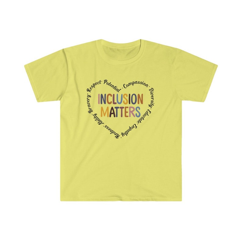 May include: A yellow t-shirt with a circle design that says "Inclusion Matters" in a heart shape. The words around the heart are "Respect, Potential, Compassion, Diversity, Educate, Empathy, Kindness, Bravery,  Adult,  and  Others."