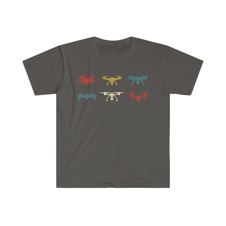May include: Dark gray t-shirt featuring six drone illustrations in red, yellow, teal, blue, white, and orange. The drones are arranged in two rows of three. The shirt is a crew neck style.