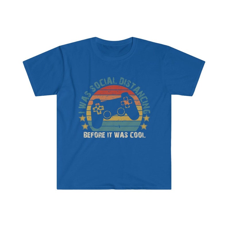 May include: A royal blue t-shirt with a vintage-style graphic of a video game controller and the text "I was social distancing before it was cool."