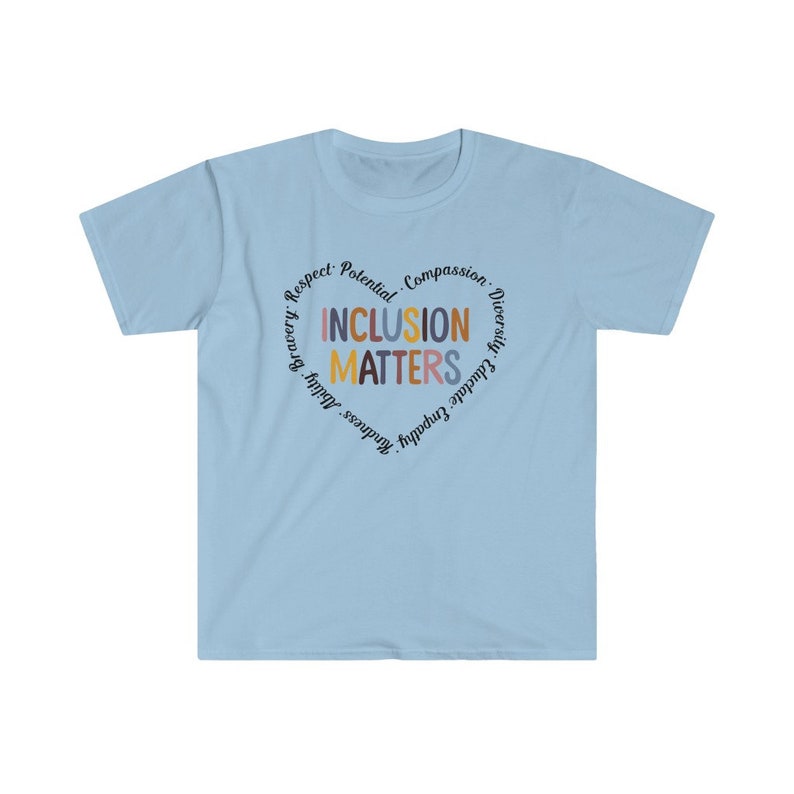 May include: Light blue t-shirt with a circle graphic that says "Inclusion Matters" in colorful letters. The circle is surrounded by the words "Respect, Potential, Compassion, Diversity, Educate, Empathy, Kindness, Bravery,  Adult,  Growth".