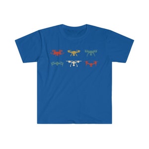 May include: A royal blue t-shirt featuring a retro design of six different drones in various colors. The drones are arranged in two rows of three, with colors including red, yellow, and teal.