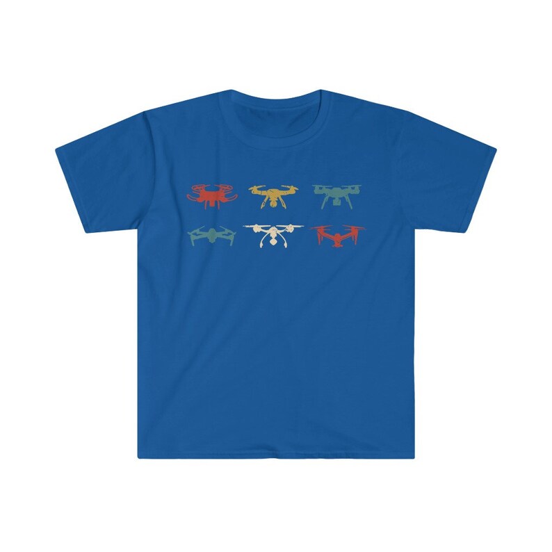 May include: A royal blue t-shirt featuring a retro design of six different drones in various colors. The drones are arranged in two rows of three, with colors including red, yellow, and teal.