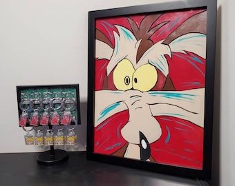 May include: A framed painting of a cartoon coyote with red, blue, and white fur. The coyote has a surprised expression with its mouth open and its eyes wide. The painting is in a black frame.