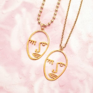 Matte Gold Winking Face Necklace: Artistic Picasso Style
