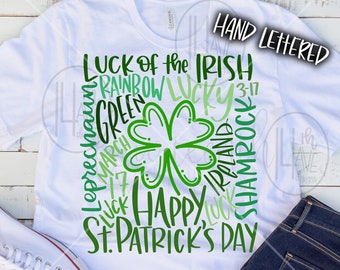 May include: White t-shirt with a green shamrock and the text "LUCK of the IRISH", "RAINBOW", "GREEN", "MARCH 17", "LUCK", "HAPPY", "LUCK", "IRELAND", "SHAMROCK", and "ST. PATRICK'S DAY" in a green gradient.