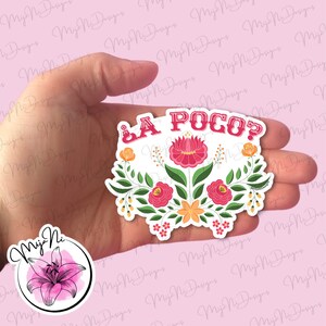 May include: A floral sticker with the text "¿A POCO?" in red. The sticker features a central pink flower, surrounded by green leaves, orange and pink flowers, and white accents. A logo with a pink lily is in the lower left corner.