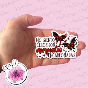May include: A sticker with a red butterfly design and the text "No siento celos son mariposas encabronadas".