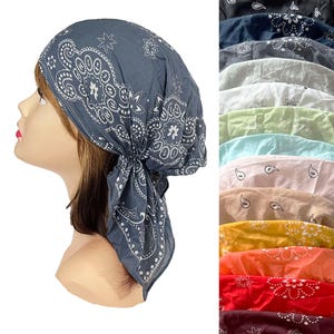 May include: A collection of head scarves featuring a traditional paisley and floral bandana print. The scarves are available in a variety of colors including dark gray, black, navy, white, light green, light blue, pink, beige, yellow, orange, red, and maroon.