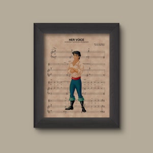 May include: A framed print of sheet music for the song "Her Voice" from the Disney movie "The Little Mermaid". The music features a cartoon image of Prince Eric, the male lead, standing with his arms crossed. The title of the song is printed at the top of the sheet music.