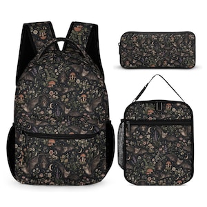 May include: A backpack, a rectangular pencil case, and a lunch bag, all featuring a dark black background with a repeating pattern of brown bats, colourful mushrooms, small flowers, green ferns, and crescent moons, with black zips and mesh side pockets.