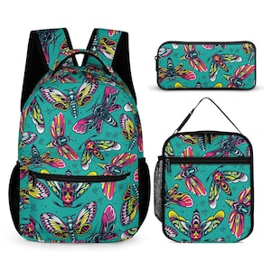 May include: A backpack, a rectangular pencil case, and a lunch bag, all featuring a vibrant teal background with a repeating pattern of colourful moths with skull-like markings on their bodies in shades of pink, yellow, and black.
