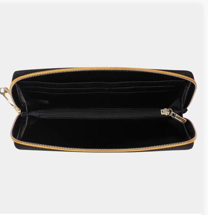 May include: Black zippered wallet with gold zipper pulls. The wallet is open and the interior is visible.