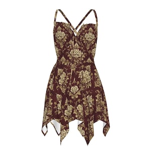 May include: A burgundy dress with a floral pattern in gold and cream. The dress features a crisscross bodice, spaghetti straps, and an asymmetrical hemline. The fabric has a damask-like design.