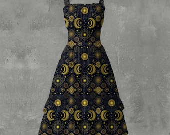 May include: A black dress with a celestial pattern of gold moons, stars, and suns. The dress has a square neckline, spaghetti straps, and a flared skirt. The dress is approximately 40 inches long.
