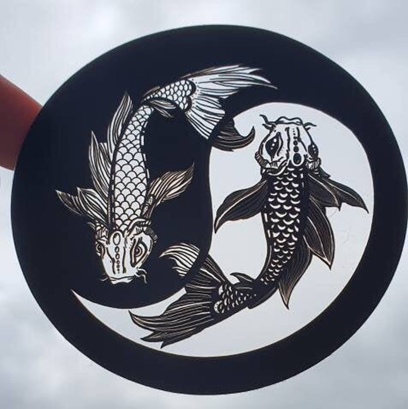 May include: A black and white Yin and Yang design featuring two koi fish. The fish are intricately detailed with scales and fins, set against a black background with a white circular element. The design is circular.