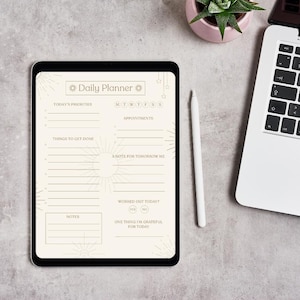 May include: A digital daily planner on a tablet with a white stylus, a laptop, and a small potted plant. The planner has sections for priorities, appointments, and notes. The text "Daily Planner" is at the top.