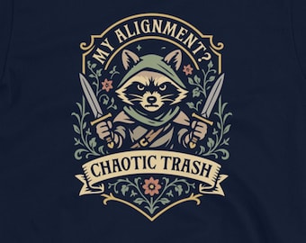 May include: Navy blue t-shirt featuring a raccoon character with two knives, wearing a hood, and the text "My Alignment? Chaotic Trash." The design is framed with floral elements.