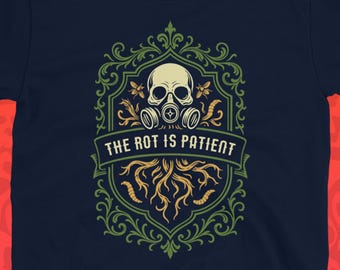 May include: Navy blue t-shirt featuring a skull with a gas mask, set within a decorative emblem. The emblem includes the text "THE ROT IS PATIENT" and a root-like design. The background is a pattern of red skulls.