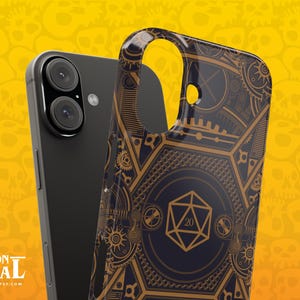 May include: Black smartphone with a detailed phone case featuring a gold and navy blue geometric design. The case has a D20 die symbol and gear-like patterns. The background is yellow with skull graphics. The Dungeon Arsenal logo is visible.
