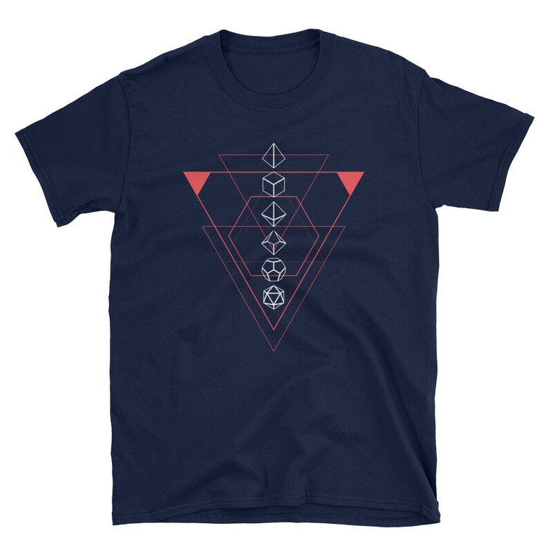 May include: Navy blue t-shirt with a geometric design featuring five white dice in a triangle shape. The triangle is outlined in pink.