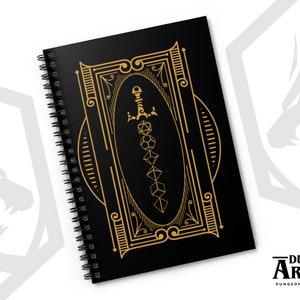 May include: A black spiral notebook with a gold design featuring a sword and dice. The design is framed with an ornate border. The notebook says "Dungeon Arsenal" on the bottom.