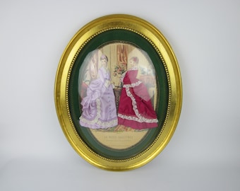 May include: An oval framed picture with a gold frame and a green mat. The picture shows two women in elaborate dresses, one in purple and one in red. The text "La Mode Illustree" is visible at the bottom of the picture.