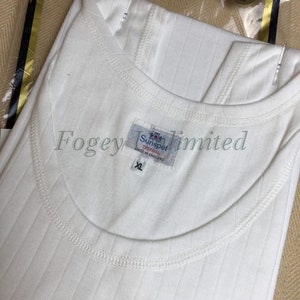 May include: White ribbed undershirt with a crew neck and the text "Sunspel" and "The Original" on the label. The label also states "Made in England" and "XL".
