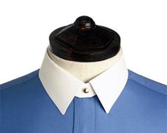 May include: A blue dress shirt with a white collar and a single button closure. The collar is a wingtip style.